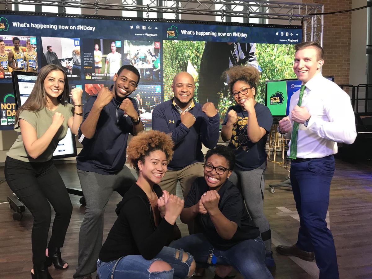 Mike Brown (center) and Samuel Jackson (back row, left) pose like the Leprechaun at Notre Dame Day.