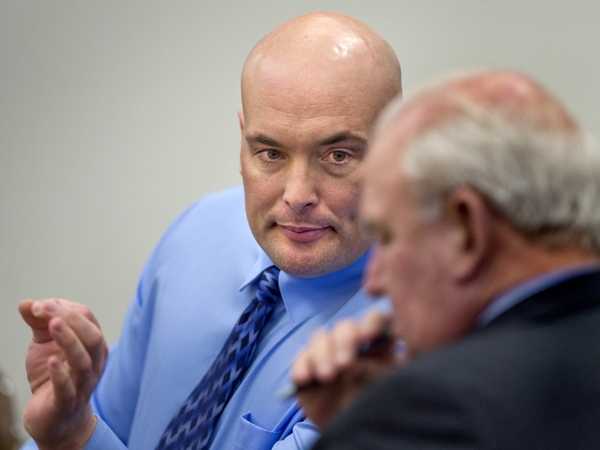Naposki talks with one of his two attorneys, Gary Pohlson, during in his murder trial in 2011.