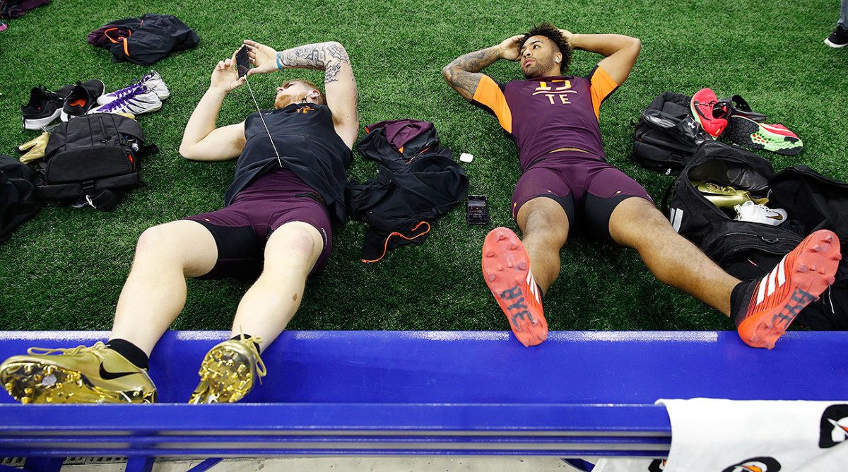 Jace Sternberger and Irv Smith Jr. (right) wait around at the NFL combine in their Under Armour apparel while wearing Nike and adidas cleats respectively.