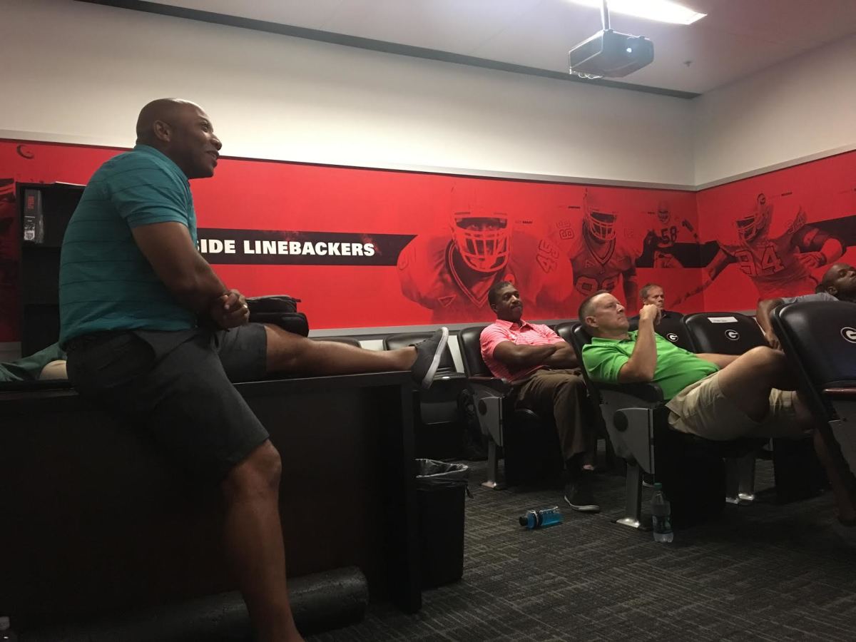 James Carter, far left, leads his officiating crew through a meeting from the Georgia outside linebackers position room. Carter's crew embedded for two days in UGA camp.