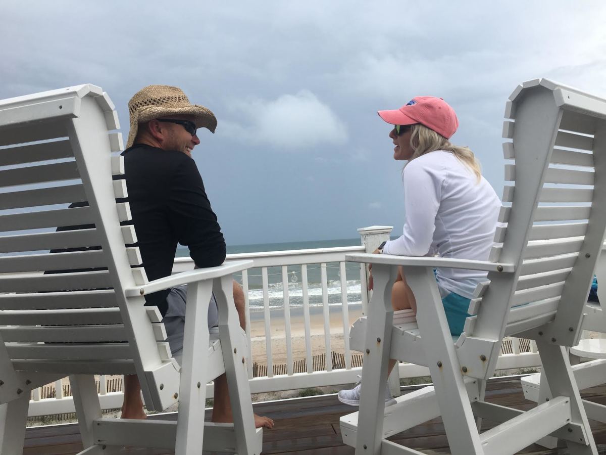 Matt Canada and wife Erin enjoy the sounds of crashing waves while on the porch of their beach house on Topsail Island, a barrier island off the coast of North Carolina.