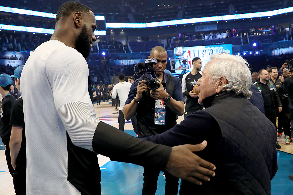 Robert Kraft (right) shakes hands with LeBron James at NBA All-Star Weekend.