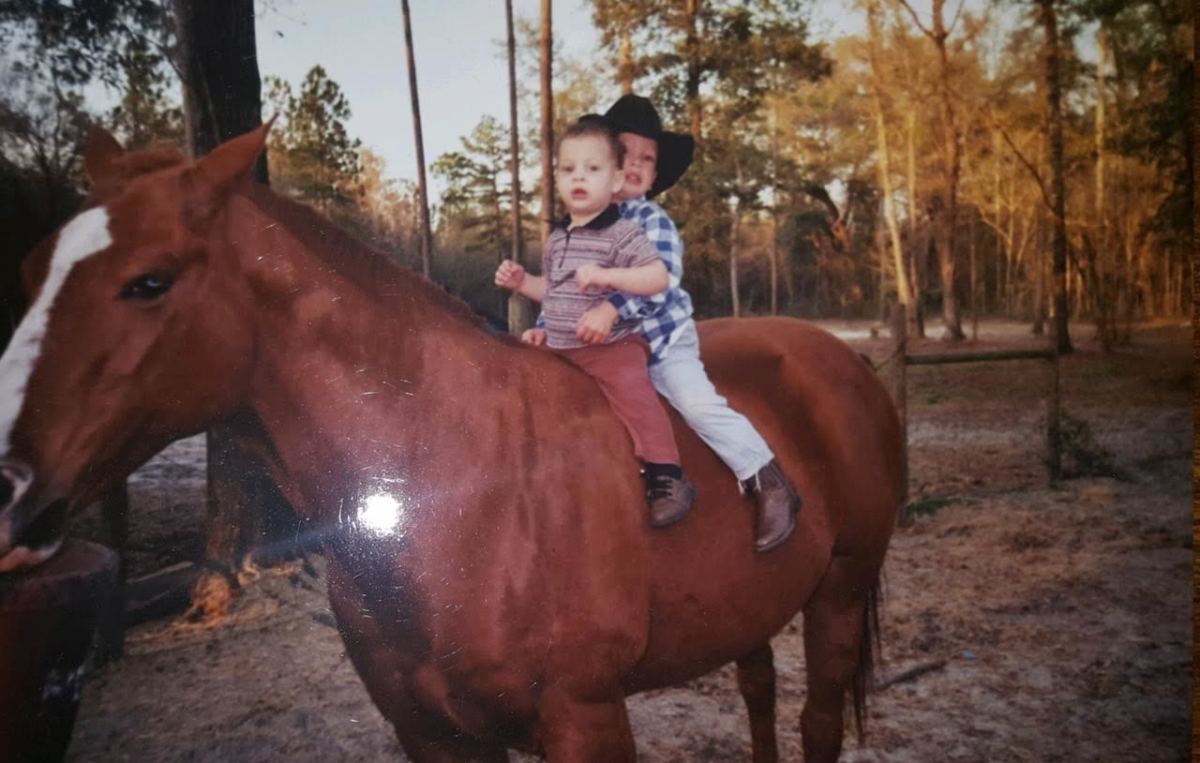 Jordan and Feleipe ride atop a horse on the family's land in rural Wakulla County, just south of Tallahassee, Florida.