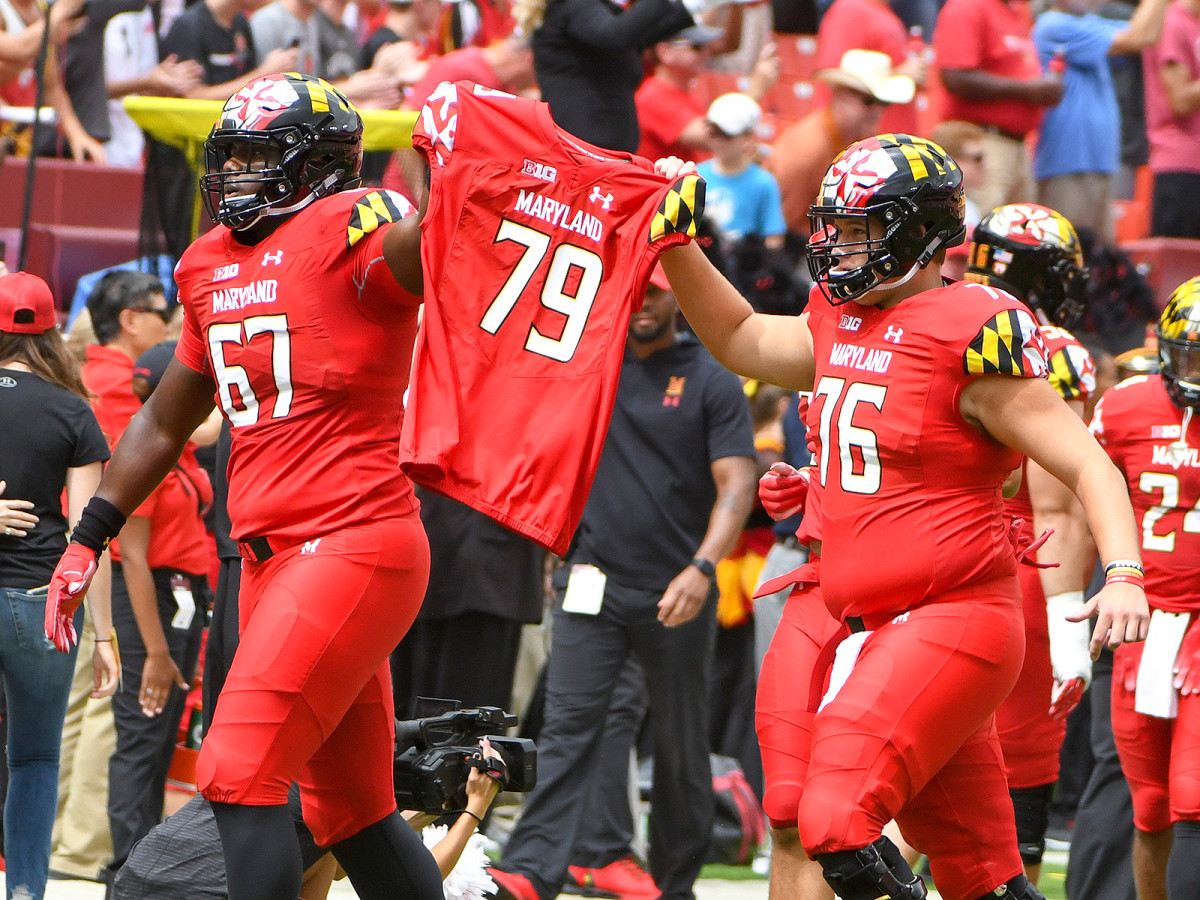 Maryland players hold up the jersey of Jordan McNair before a 2018 game against Texas.