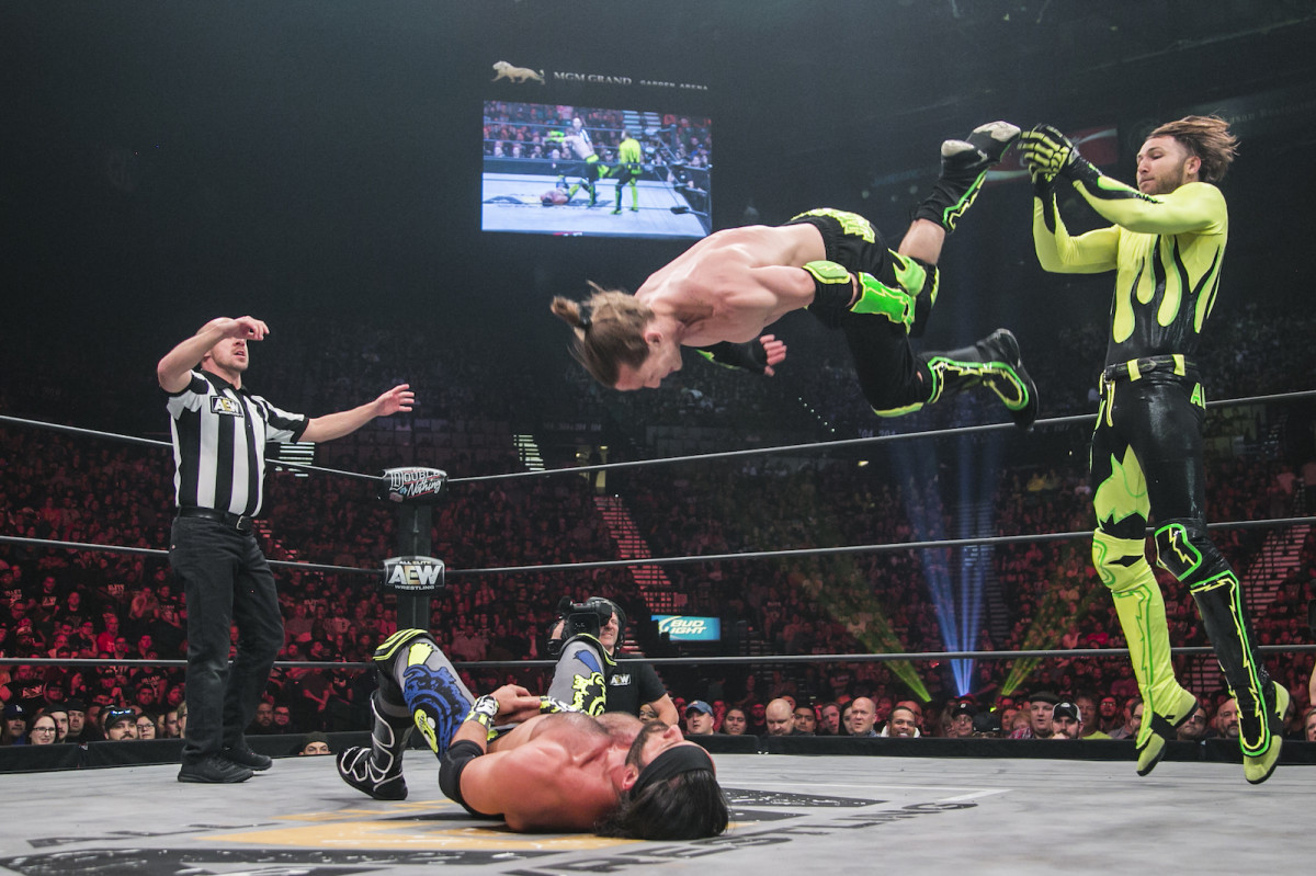 South African luchador Angélico (standing) and his American tag team partner Jack Evans. 