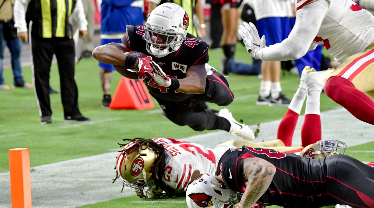 Oct 31, 2019; Glendale, AZ, USA; Arizona Cardinals running back Kenyan Drake (41) dives over San Francisco 49ers cornerback Richard Sherman (25) to score a touchdown  in the first quarter at State Farm Stadium. Mandatory Credit: Matt Kartozian-USA TODAY Sports