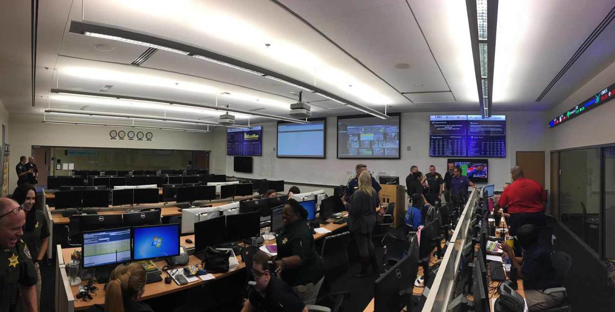 Officers and other officials gather in a computer lab at LSU’s College of Business, which has been turned into a game day command center. 