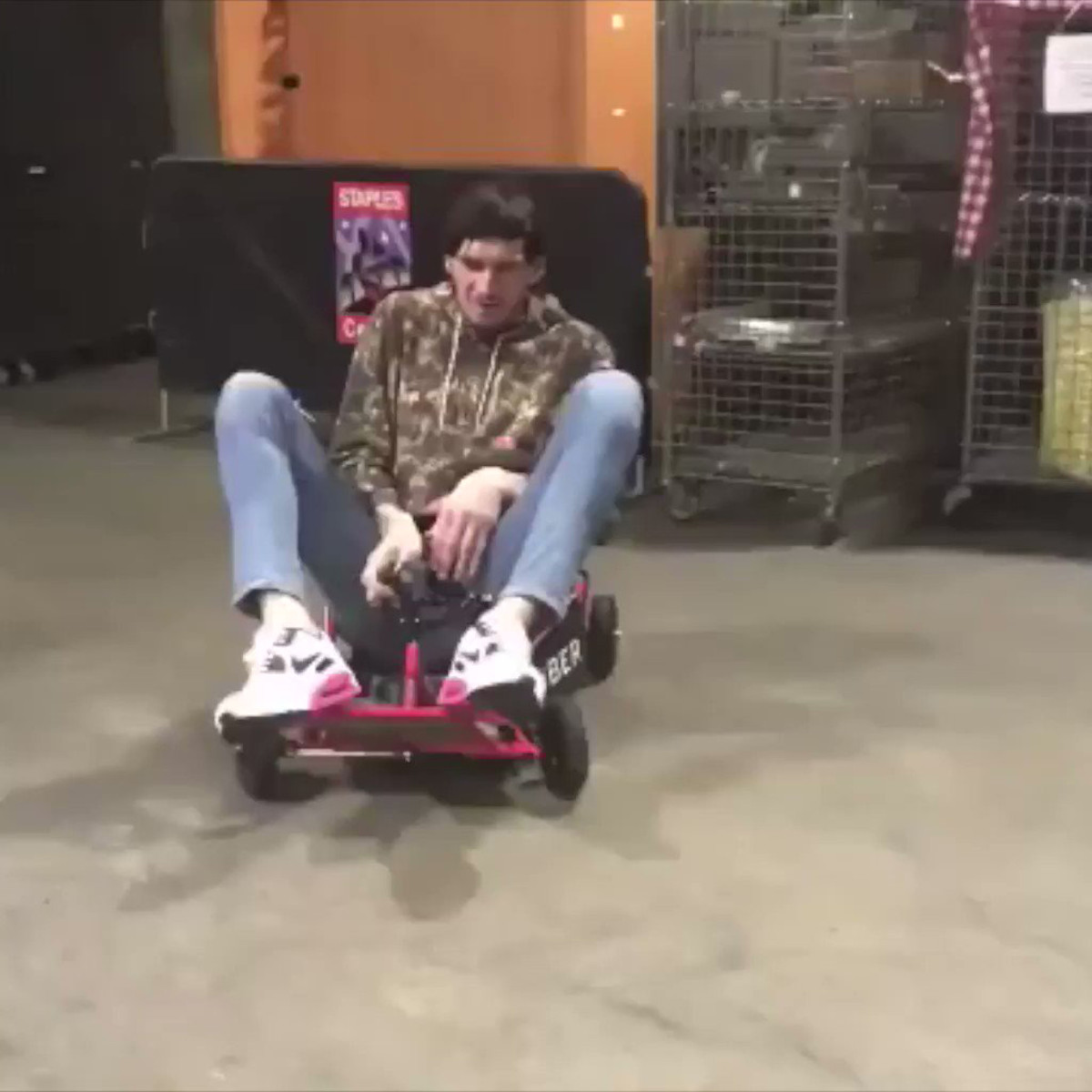 Seven foot-plus NBA player rides around arena in go-kart