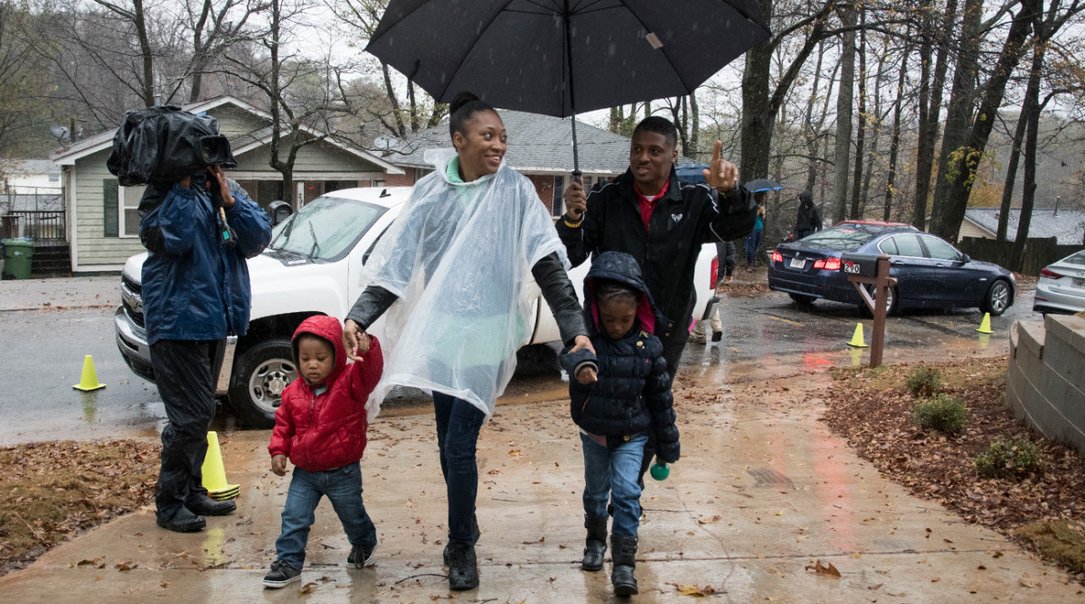 Dunn escorts a family into their new house in December, the 159th that his Home for the Holidays charity has provided for single moms and their kids.