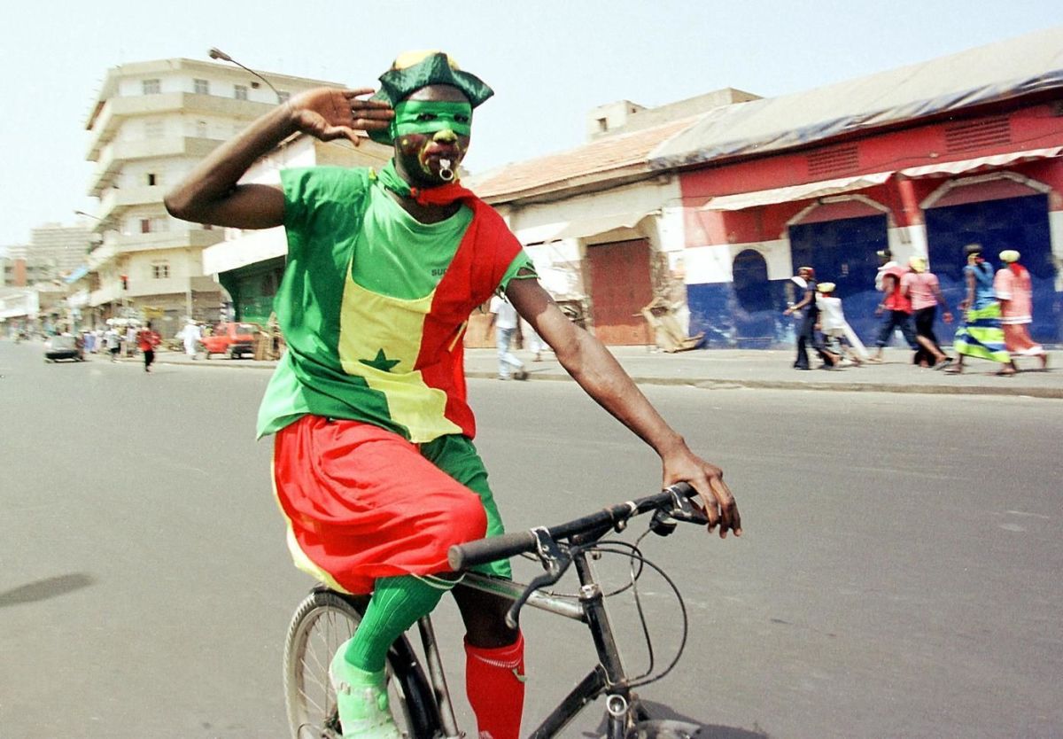 an-elated-senegalese-soccer-supporter-rides-his-bi-5b150c97347a0288ab000001.jpg