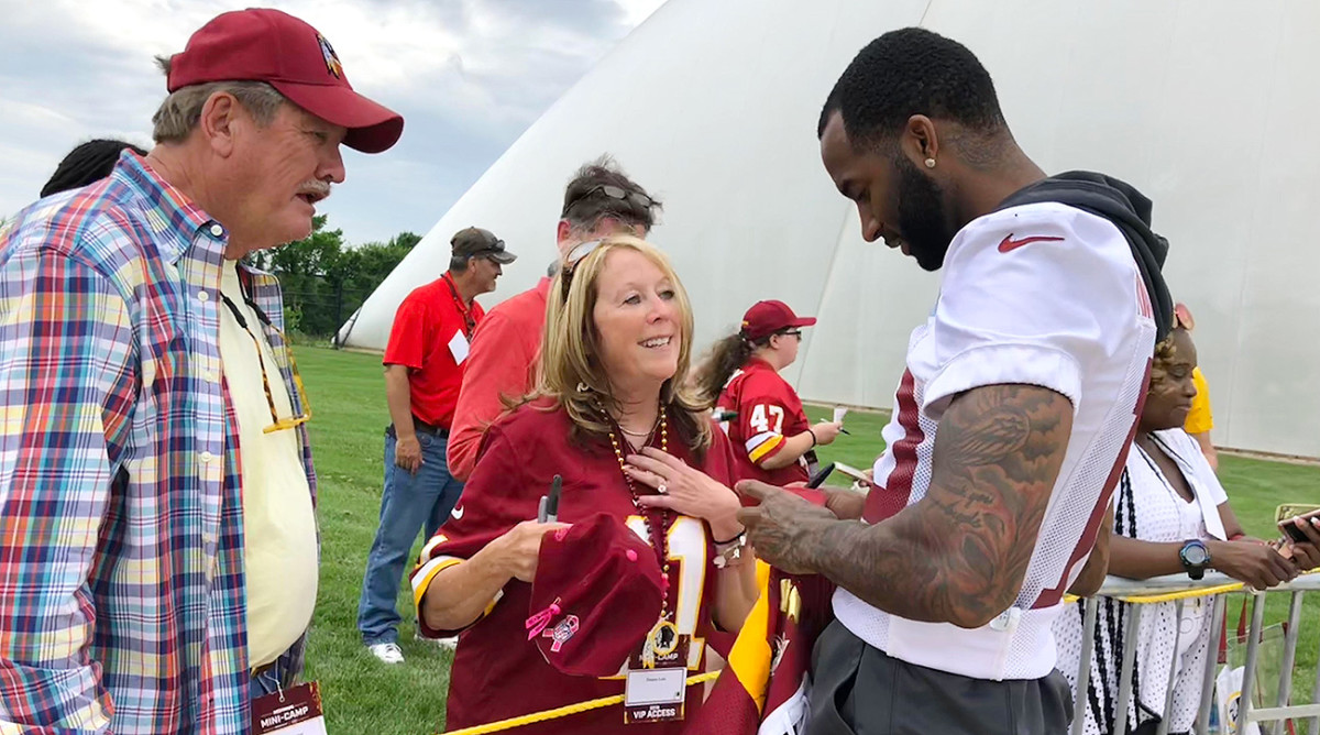 Longtime Washington fan Gene Bogley and his fiancée Donna Late—wearing her No. 11 Alex Smith jersey—take in the team’s minicamp practice.