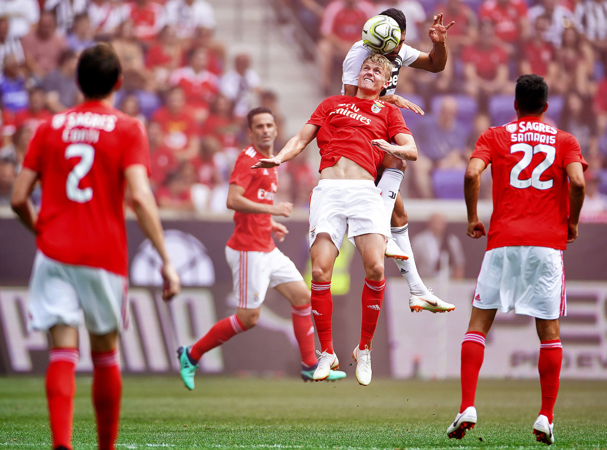 Juventus FC midfielder Emre Can heading a ball vs. SL Benfica's Keaton Parks at the International Champions Cup