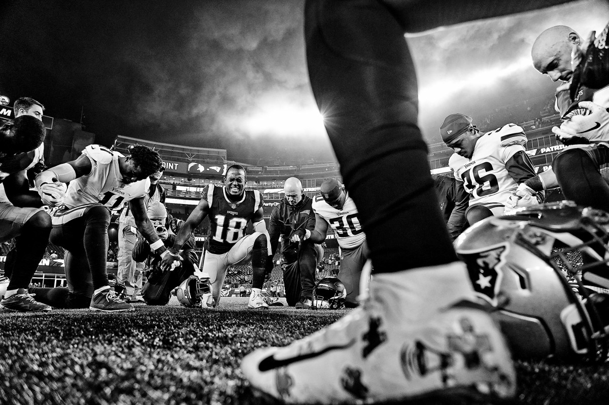 New England Patriots' Matthew Slater (18) with teammates and Minnesota Vikings players, praying in the endzone after a game at Gillette Stadium