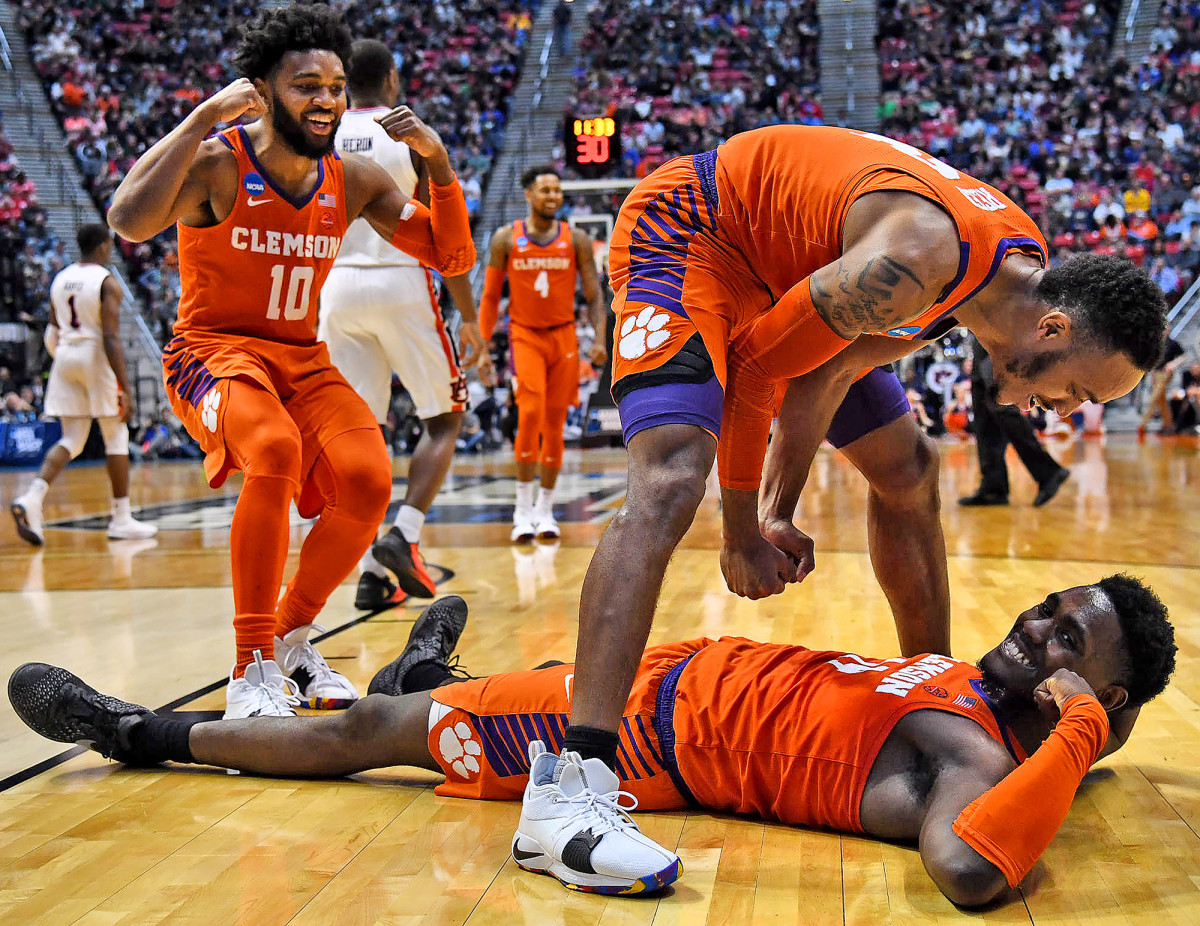Elijah Thomas down on court with Marcquise Reed of Clemson after a game against Auburn in Round 2 of the NCAA tournament