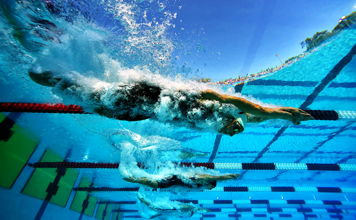 Claire Tuggle and Brooke Forde enter the water at the 2018 Phillips 66 National Championships