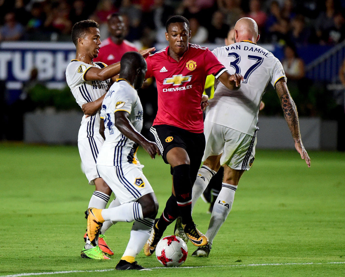 CARSON, CA - JULY 15:  Anthony Martial #11 of Manchester United dribbles between Ema Boateng #24 and Giovani dos Santos #10 of Los Angeles Galaxy during the second half at StubHub Center on July 15, 2017 in Carson, California.  Manchester United beat the Los Angeles Galaxy 5-2.  (Photo by Harry How/Getty Images)