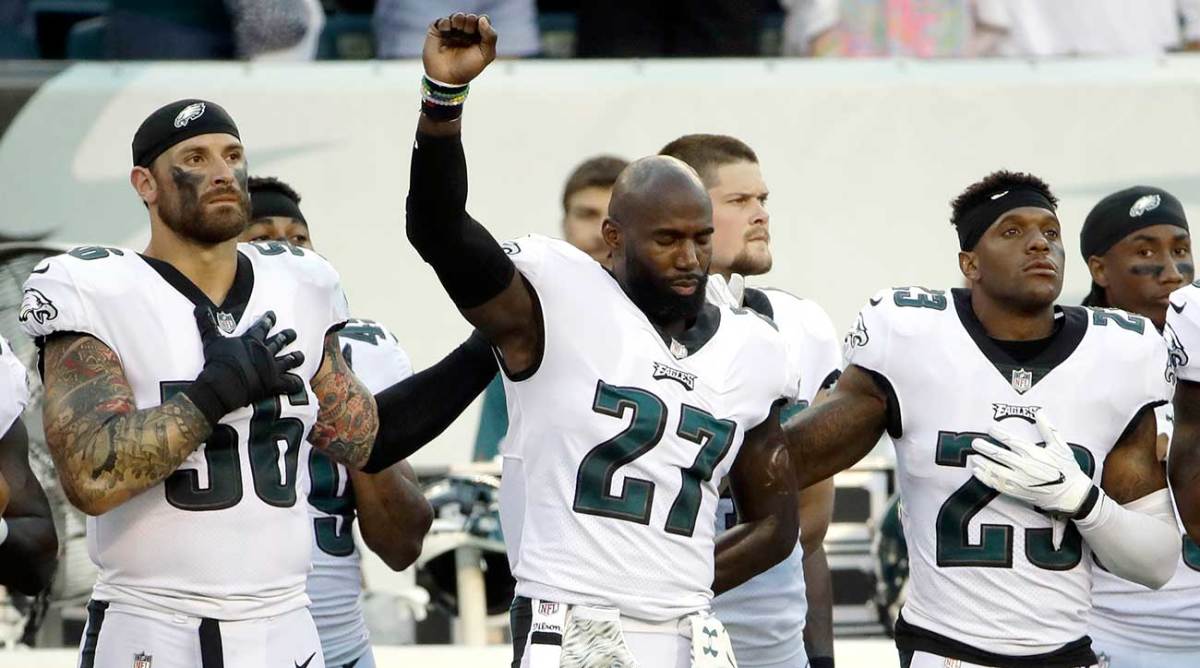 Chris Long, Malcolm Jenkins and Rodney McLeod stand in solidarity before the Eagles-Dolphins game. Jenkins began raising his fist during the 2016 season. 