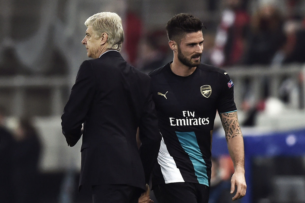Arsenal's French forward Olivier Giroud (R) celebrates with Arsenal's French Coach Arsene Wenger  during the UEFA Champions League Group F football match between Olympiacos and Arsenal at the Georgios Karaiskakis Stadium in Piraeus near Athens on December 9, 2015. Arsenal won the match 0-3. AFP PHOTO / ANGELOS TZORTZINIS / AFP / ANGELOS TZORTZINIS        (Photo credit should read ANGELOS TZORTZINIS/AFP/Getty Images)