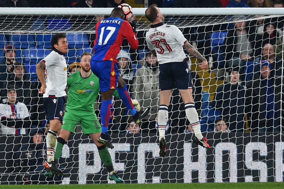 Crystal Palace's Zaire-born Belgian striker Christian Benteke (2nd R) jumps to head their first goal during the English FA Cup third round replay football match between Crystal Palace and Bolton Wanderers at Selhurst Park in south London on January 17, 2017. / AFP / GLYN KIRK / RESTRICTED TO EDITORIAL USE. No use with unauthorized audio, video, data, fixture lists, club/league logos or 'live' services. Online in-match use limited to 75 images, no video emulation. No use in betting, games or single club/league/player publications.  /         (Photo credit should read GLYN KIRK/AFP/Getty Images)