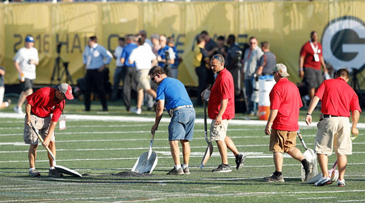 Crews work on the field before the 2016 Hall of Fame Game between the Packers and Colts. Ultimately, the game was canceled due to the poor field conditions. 