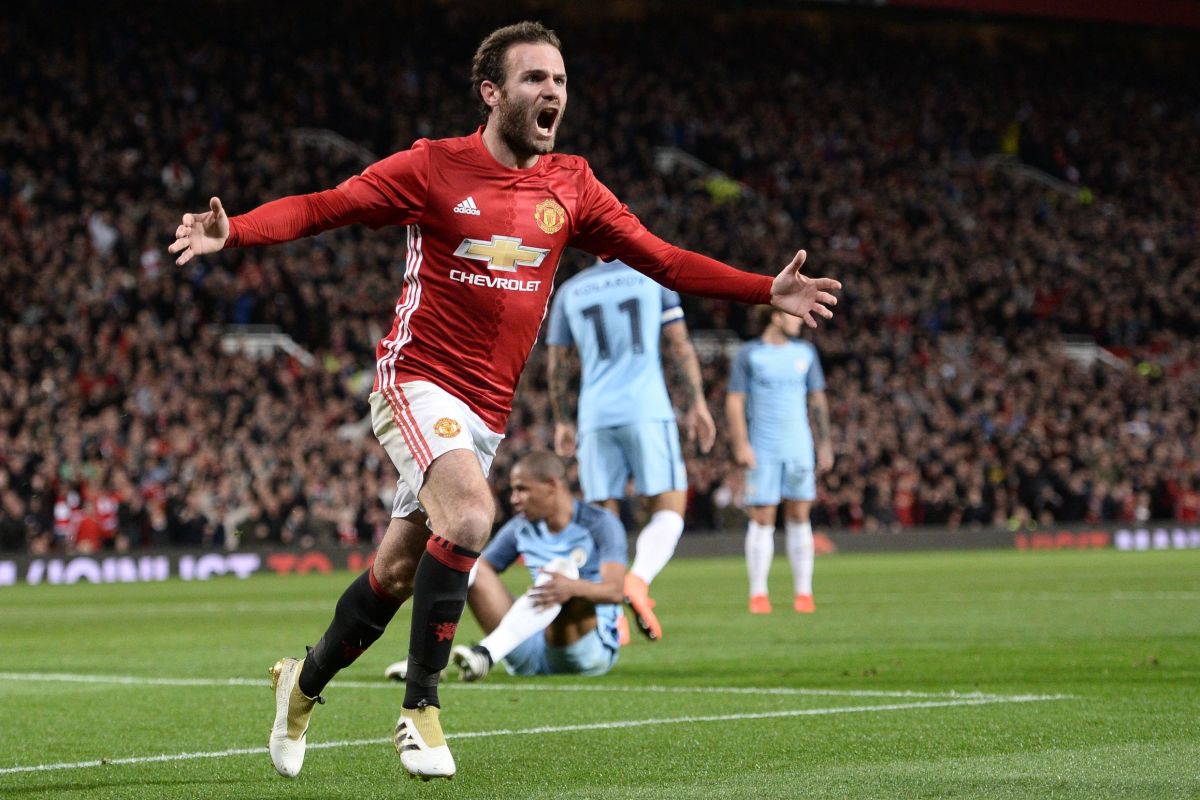 Manchester United's Spanish midfielder Juan Mata celebrates after scoring the opening goal of the EFL (English Football League) Cup fourth round match between Manchester United and Manchester City at Old Trafford in Manchester, north west England on October 26, 2016. / AFP / Oli SCARFF / RESTRICTED TO EDITORIAL USE. No use with unauthorized audio, video, data, fixture lists, club/league logos or 'live' services. Online in-match use limited to 75 images, no video emulation. No use in betting, games or single club/league/player publications.  /         (Photo credit should read OLI SCARFF/AFP/Getty Images)