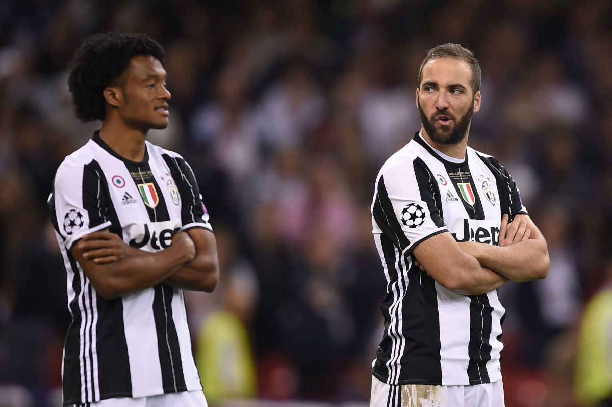 Juventus' Colombian midfielder Juan Cuadrado (L) and Juventus' Argentinian striker Gonzalo Higuain react after Real Madrid won the UEFA Champions League final football match between Juventus and Real Madrid at The Principality Stadium in Cardiff, south Wales, on June 3, 2017. / AFP PHOTO / Filippo MONTEFORTE        (Photo credit should read FILIPPO MONTEFORTE/AFP/Getty Images)