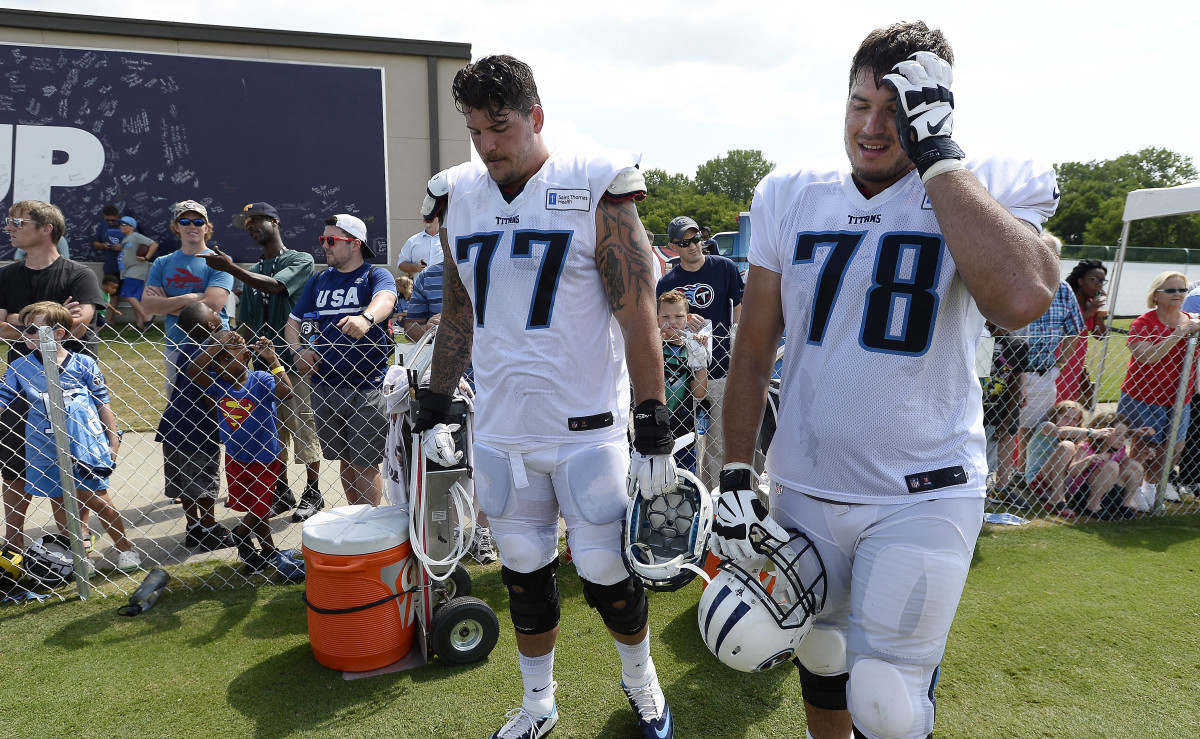 Tennessee tackles Taylor Lewan and Jack Conklin take a break during training camp.