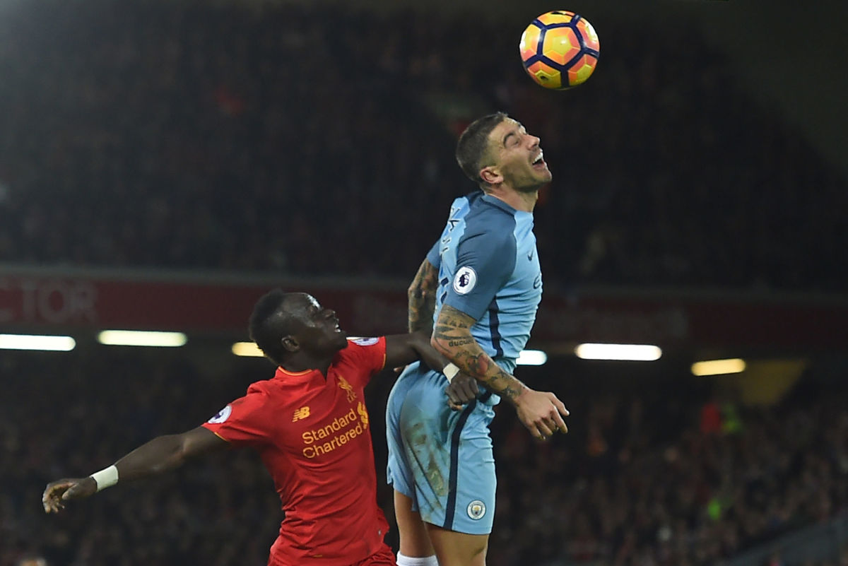 Manchester City's Serbian defender Aleksandar Kolarov (R) vies with Liverpool's Senegalese midfielder Sadio Mane during the English Premier League football match between Liverpool and Manchester City at Anfield in Liverpool, north west England on December 31, 2016. / AFP / Paul ELLIS / RESTRICTED TO EDITORIAL USE. No use with unauthorized audio, video, data, fixture lists, club/league logos or 'live' services. Online in-match use limited to 75 images, no video emulation. No use in betting, games or single club/league/player publications.  /         (Photo credit should read PAUL ELLIS/AFP/Getty Images)