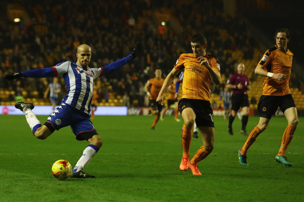 WOLVERHAMPTON, ENGLAND - FEBRUARY 14: Gabriel Obertan of Wigan shoots as Conor Coady of Wolverhampton closes in  during the Sky Bet Championship match between Wolverhampton Wanderers and Wigan Athletic at Molineux on February 14, 2017 in Wolverhampton, England.  (Photo by Michael Steele/Getty Images)
