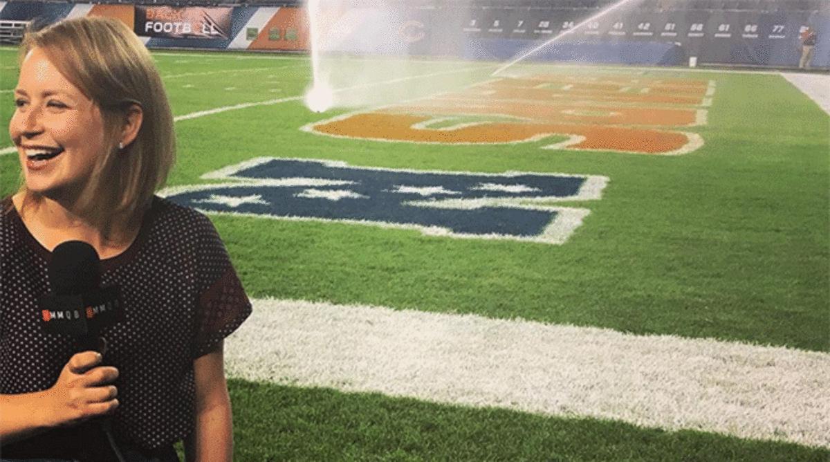 Kaplan tries to quickly record a video as the sprinklers go off after a preseason game at Soldier Field.