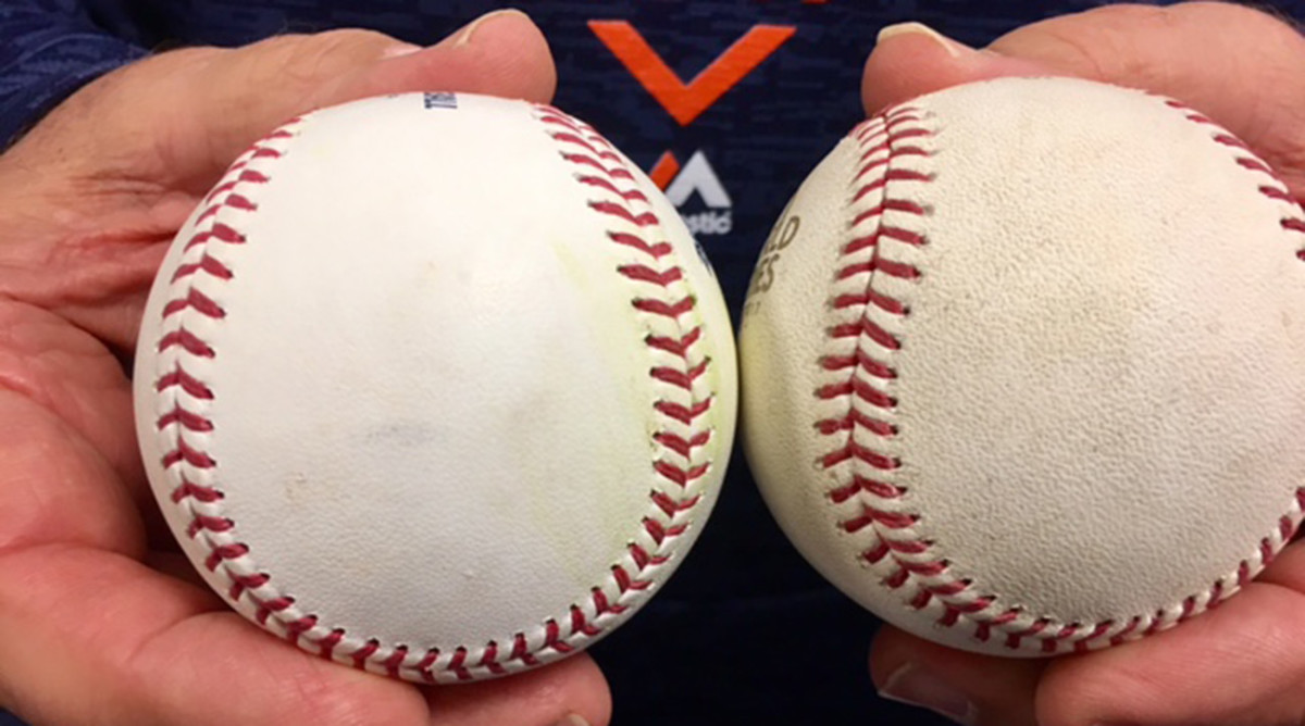 Houston pitching coach Brent Strom holds a 2017 regular season baseball (left) and a 2017 World Series ball.