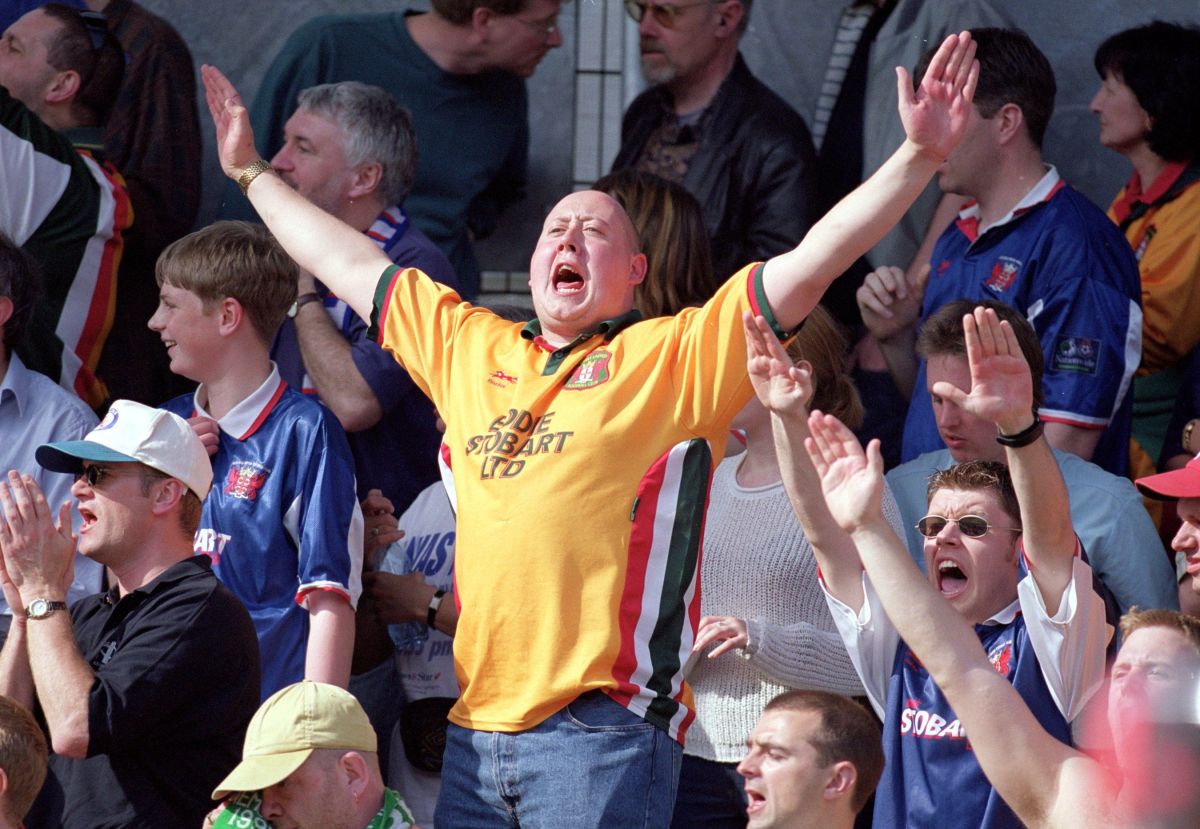 6 Apr 2000:  Carlisle United fans celebrate staying in the Nationwide Leagues after the Nationwide Division 3 game against Brighton at Withdean Stadium in Brighton, England. Brighton won 1 - 0. \ Picture by Steve Bardens. \ Mandatory Credit: Allsport UK /Allsport
