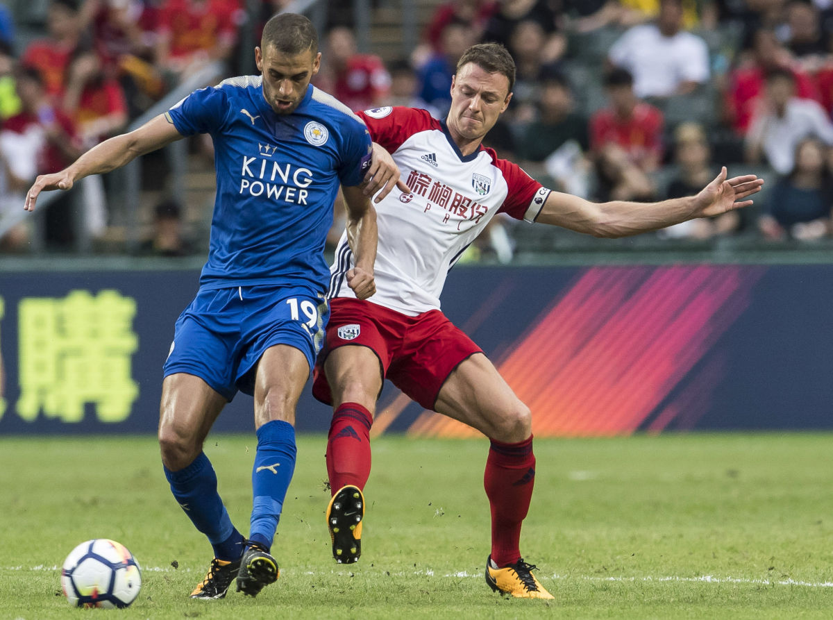 HONG KONG, HONG KONG - JULY 19: Leicester City FC forward Islam Slimani  (L) fights for the ball with West Bromwich Albion defender Jonny Evans  (R) during the Premier League Asia Trophy match between Leicester City FC and West Bromwich Albion at Hong Kong Stadium on July 19, 2017 in Hong Kong, Hong Kong. (Photo by Victor Fraile/Getty Images)