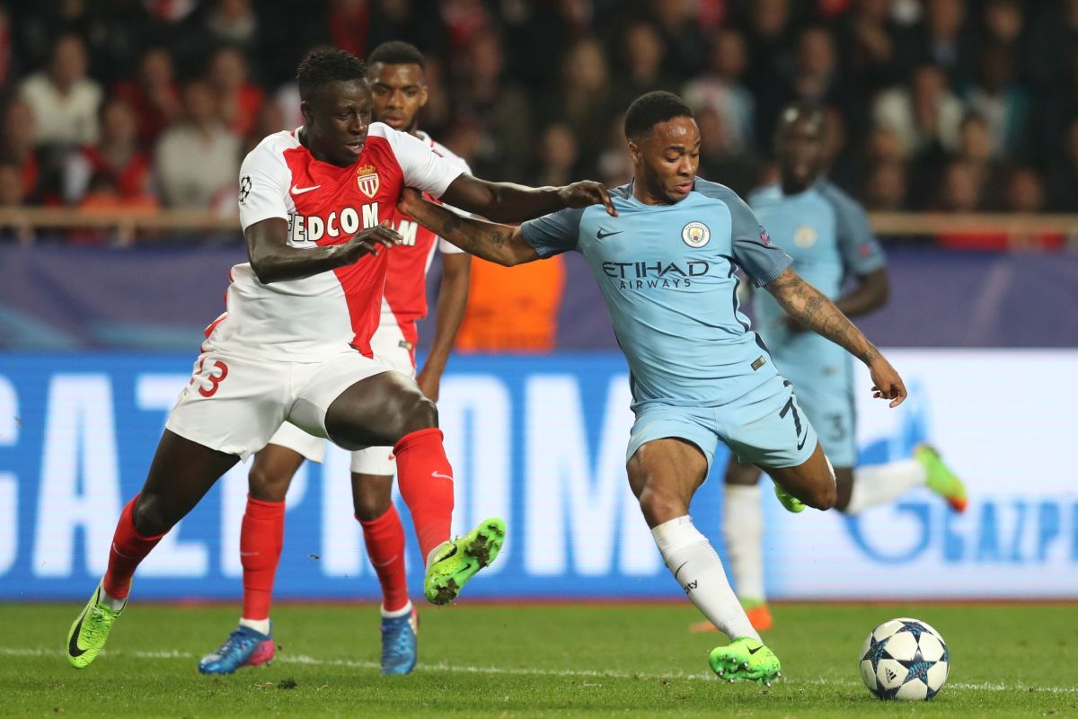 Monaco's French defender Benjamin Mendy (L) challenges Manchester City's English midfielder Raheem Sterling during the UEFA Champions League round of 16 football match between Monaco and Manchester City at the Stade Louis II in Monaco on March 15, 2017. / AFP PHOTO / Valery HACHE        (Photo credit should read VALERY HACHE/AFP/Getty Images)