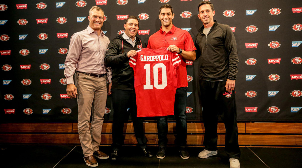 (From left to right) General manager John Lynch, CEO Jed York, Jimmy Garoppolo and coach Kyle Shanahan celebrate the quarterback’s arrival in San Francisco on Tuesday.
