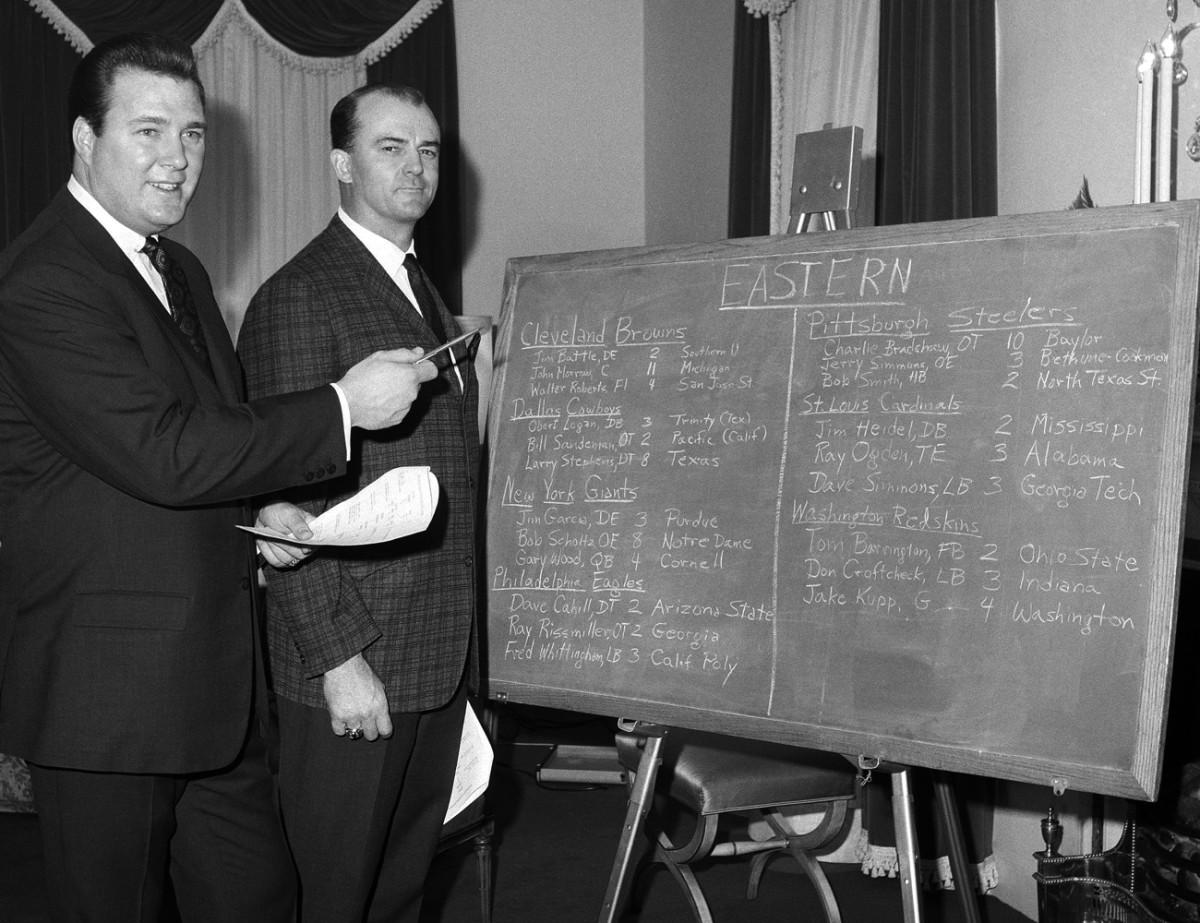 Owner John Mecom and coach Tom Fears check out expansion draft board, February 1967.