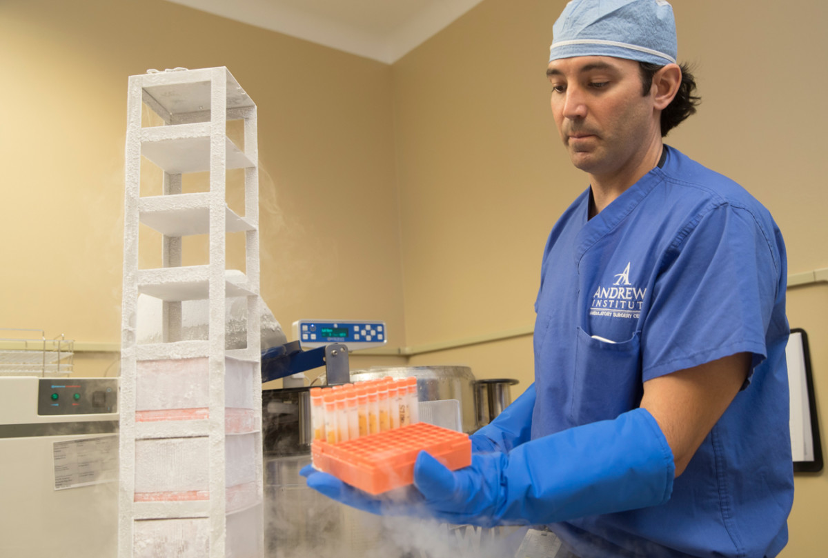 Adam Anz, M.D., retrieving cells from the liquid nitrogen vapor phase freezer in the Andrews Institute Regenerative Medicine Center.