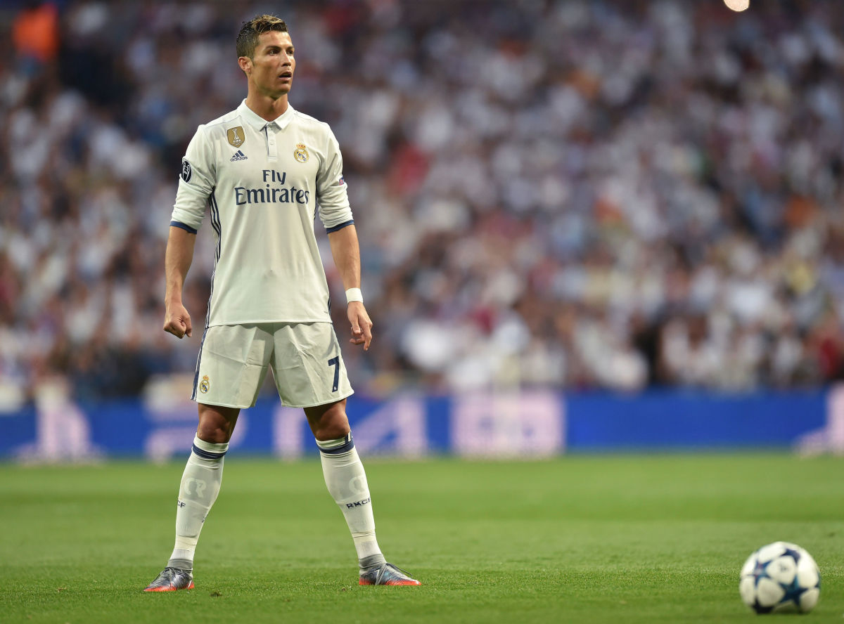 Real Madrid's Portuguese forward Cristiano Ronaldo prepares for a free kick during the UEFA Champions League quarterfinal second leg football match Real Madrid vs FC Bayern Munich at the Santiago Bernabeu stadium in Madrid, Spain, on April 18, 2017. / AFP PHOTO / Christof STACHE        (Photo credit should read CHRISTOF STACHE/AFP/Getty Images)