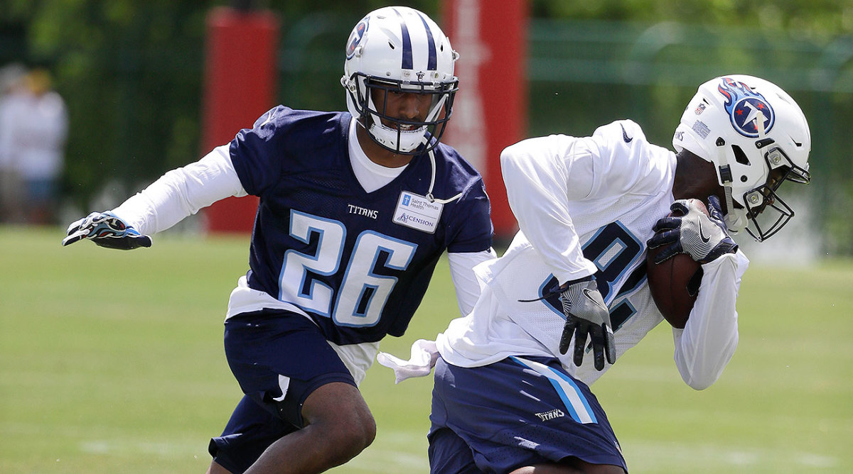 Titans WR Corey Davis (84) and CB Logan Ryan (26) run a drill during minicamp.