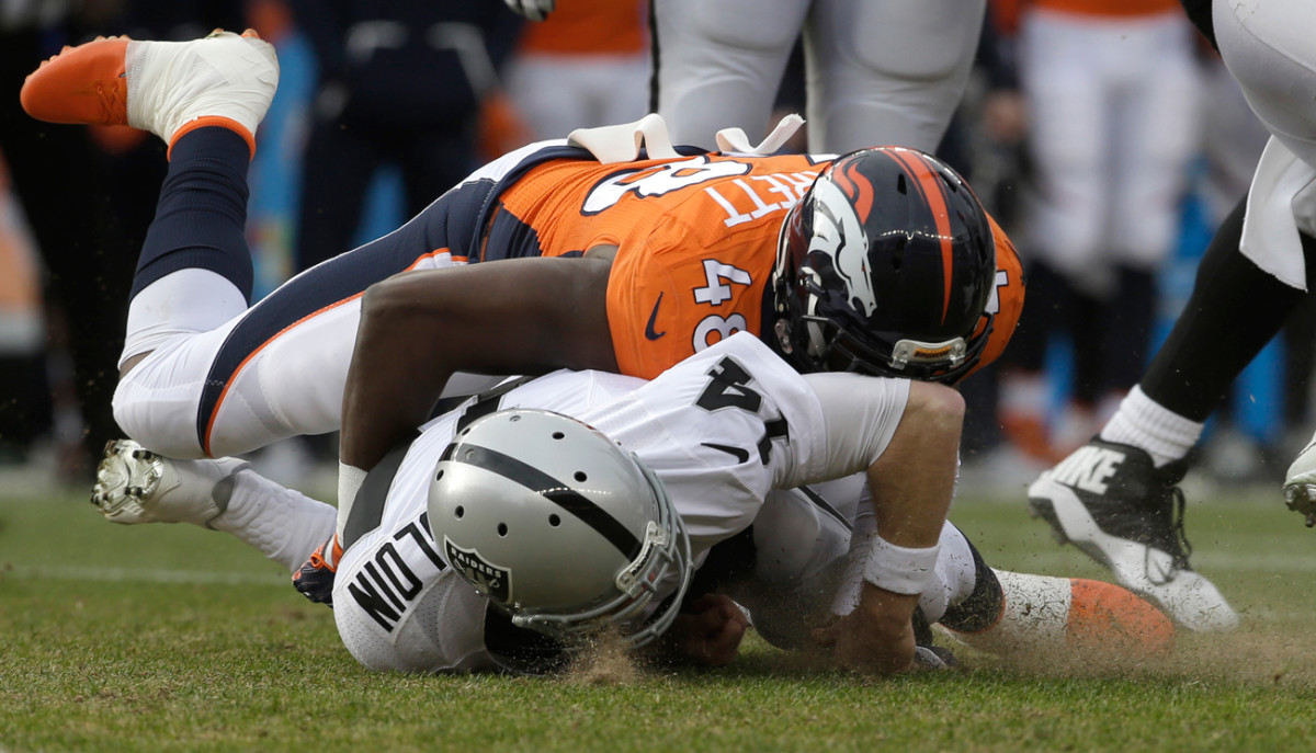 Raiders quarterback Matt McGloin was battered by the Broncos defense Sunday and eventually left the game with a shoulder injury.