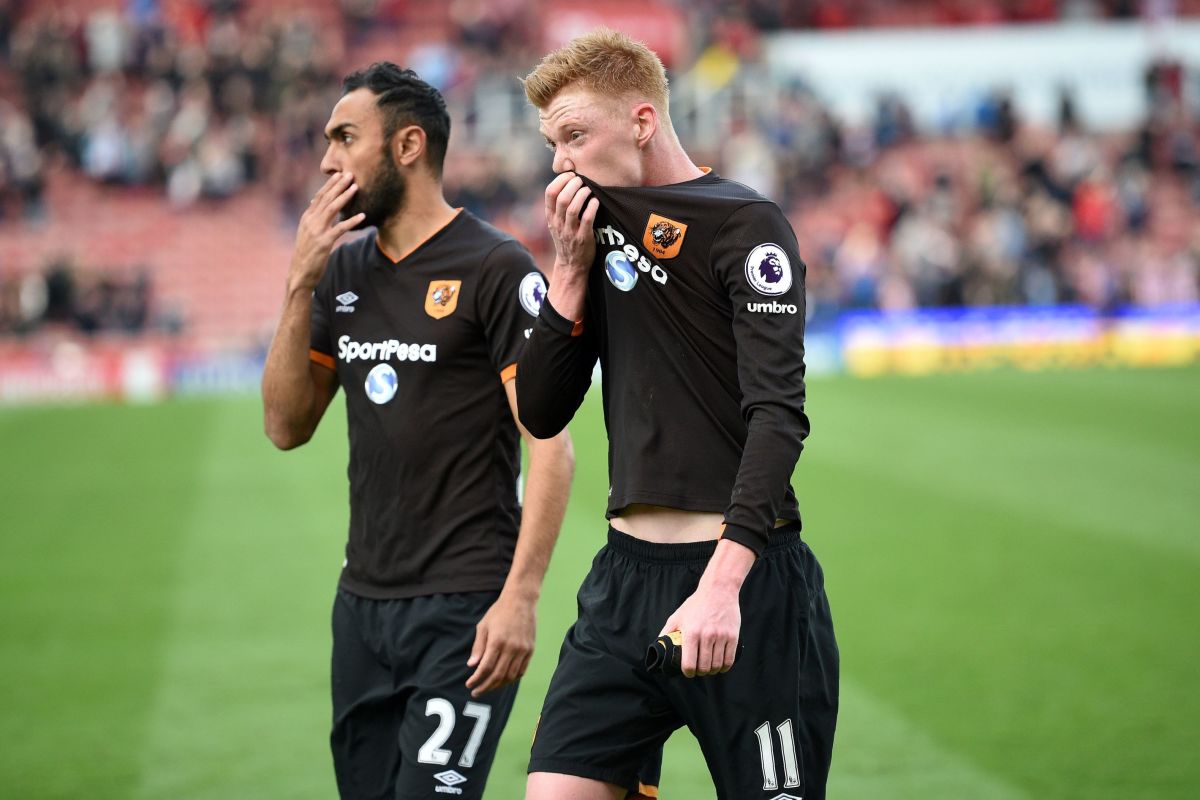 Hull City's Egyptian midfielder Ahmed Elmohamady (L) and Hull City's English midfielder Sam Clucas react to their defeat on the pitch after the English Premier League football match between Stoke City and Hull City at the Bet365 Stadium in Stoke-on-Trent, central England on April 15, 2017. / AFP PHOTO / Oli SCARFF / RESTRICTED TO EDITORIAL USE. No use with unauthorized audio, video, data, fixture lists, club/league logos or 'live' services. Online in-match use limited to 75 images, no video emulation. No use in betting, games or single club/league/player publications.  /         (Photo credit should read OLI SCARFF/AFP/Getty Images)