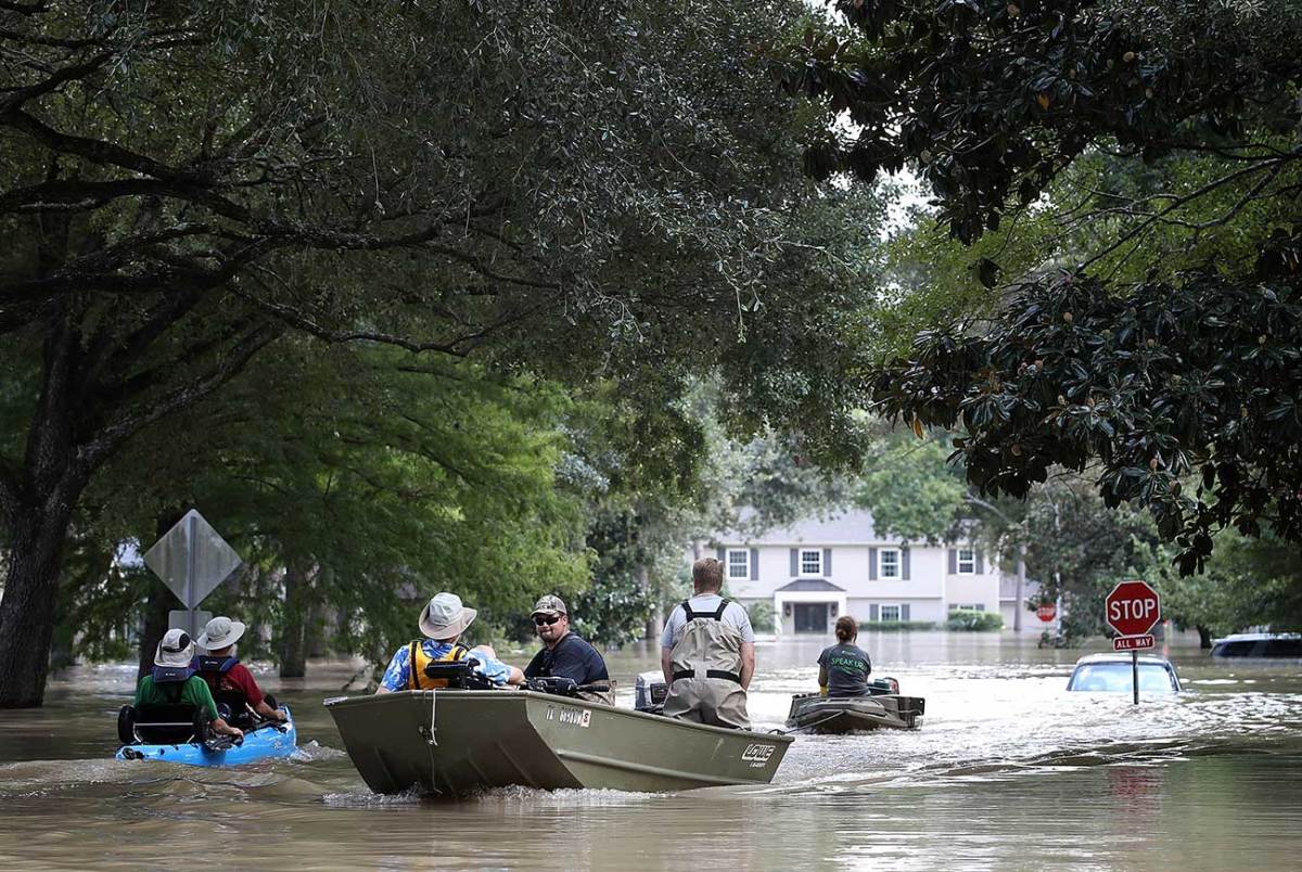 Residents and rescuers plied the streets in small boats, often the only means of navigating through the city.