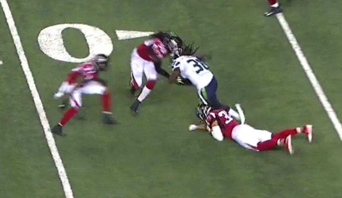 DeVondre Campbell (No. 59) makes the tackle on Seattle RB Alex Collins (No. 36).