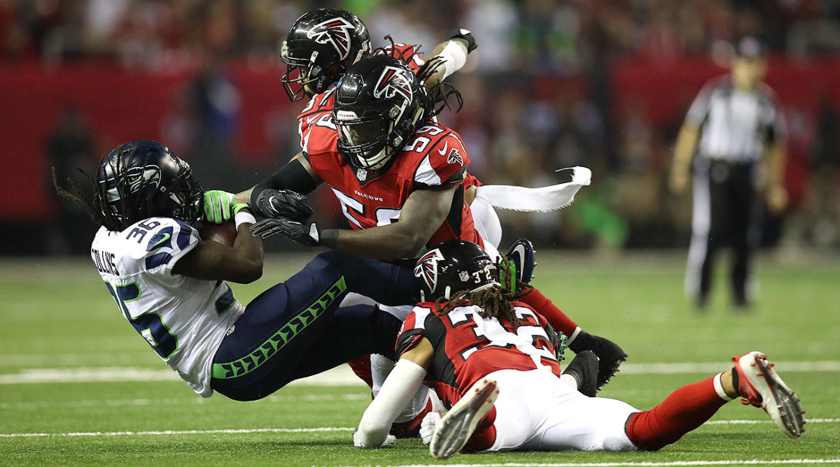 De'Vondre Campbell (59) and Jalen Collins (32) bring down Seahawks' Alex Collins (36) in the 2017 NFC Divisional round.