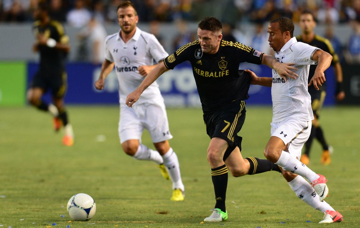 Former Tottenham Hotspur player Robbie Keane (C) of the LA Galaxy vies for the ball with Andros Townsend (R) of Tottenham as Rafael Van Der Vaart (L) looks on during their football friendly at the Home Depot Center in Carson, California on July 24, 2012. The match ended 1-1.  AFP PHOTO/Frederic J. BROWN        (Photo credit should read FREDERIC J. BROWN/AFP/GettyImages)