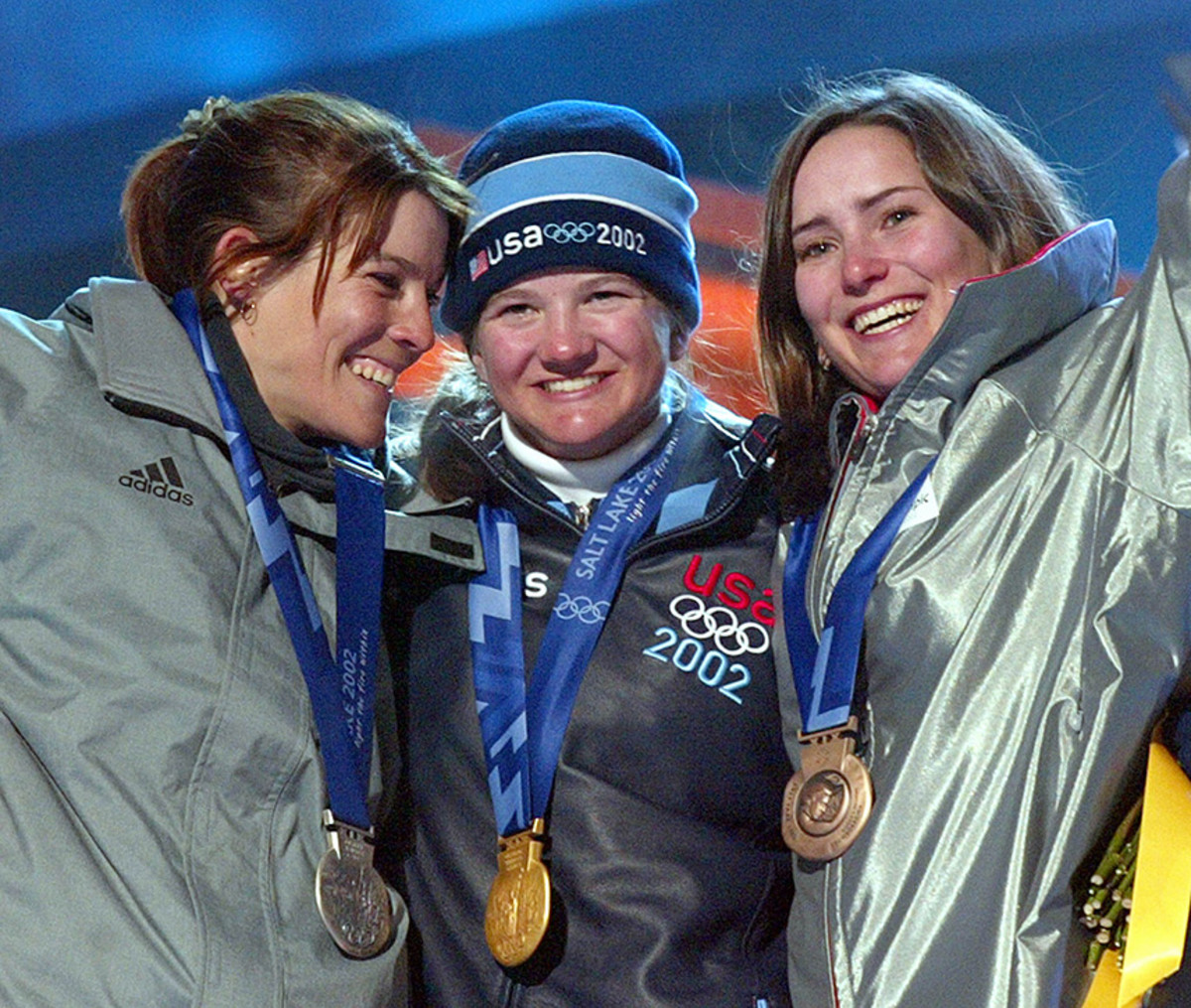Kelly Clark of the US(C), Doriane Vidal of France (R) and Fabienne Reuteler (L) of Switzerland show their medals 10 February 2002 during the medals ceremony for the Women's Halfpipe snowboard competition at the 2002 Winter Olympics in Salt Lake City, Utah. Clark won the gold, Vidal the silver and Reuteler the bronze.