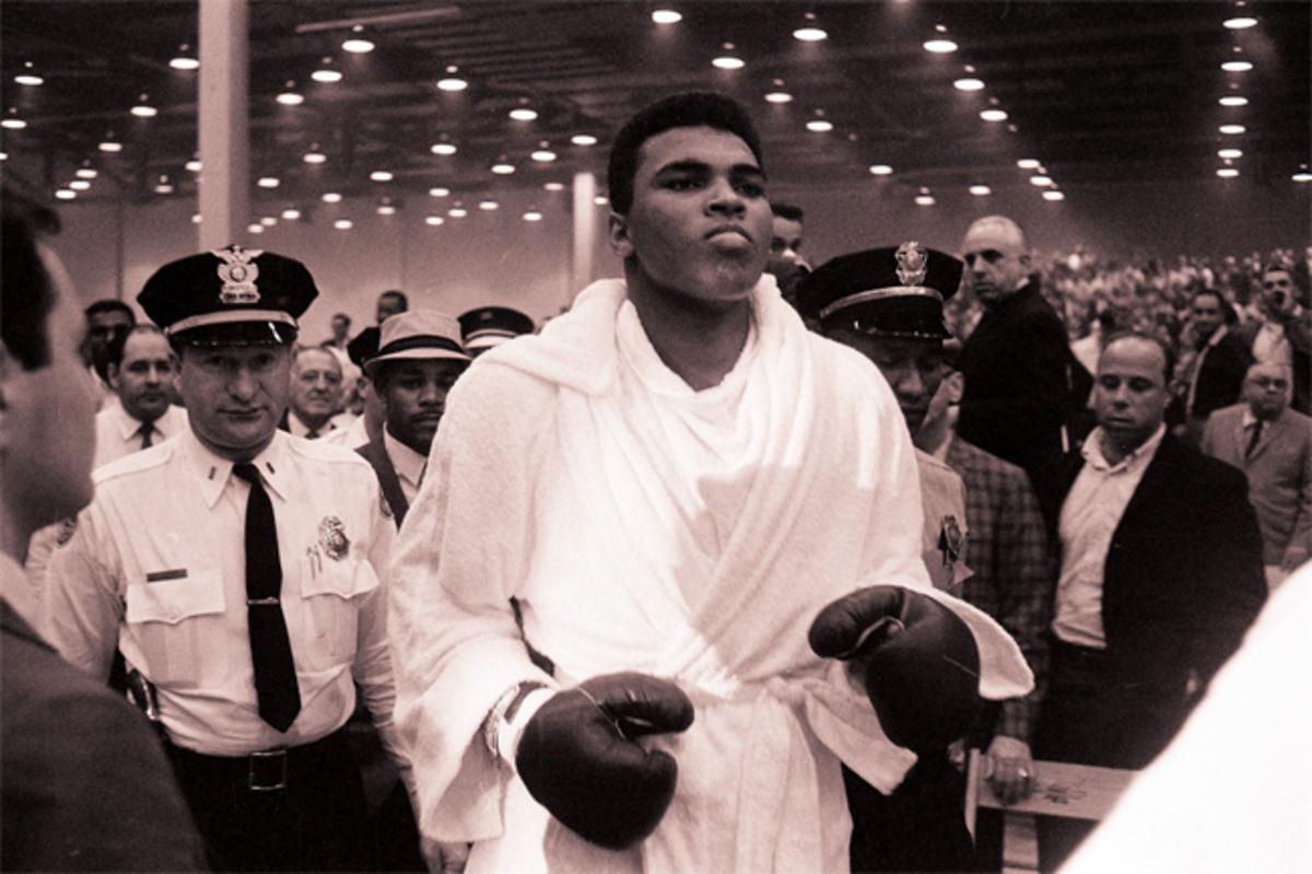 Cassius Clay walks to the ring for his February 1964 heavyweight title fight against Sonny Liston in Miami.