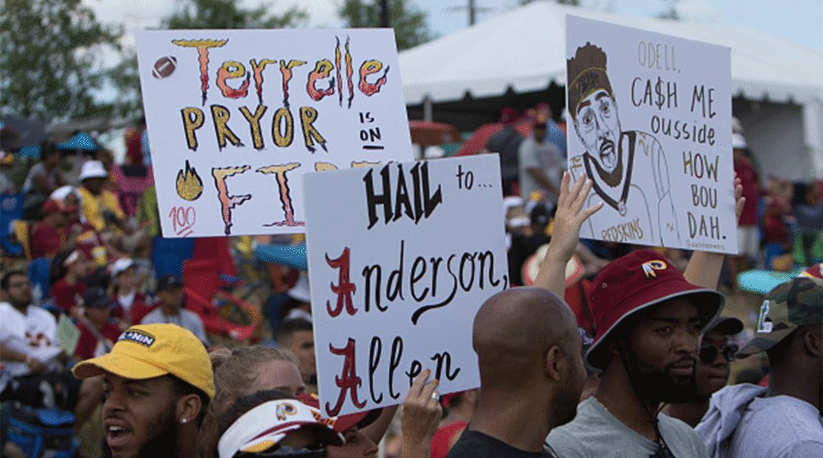 Fans hold up signs at Washington's training camp. 