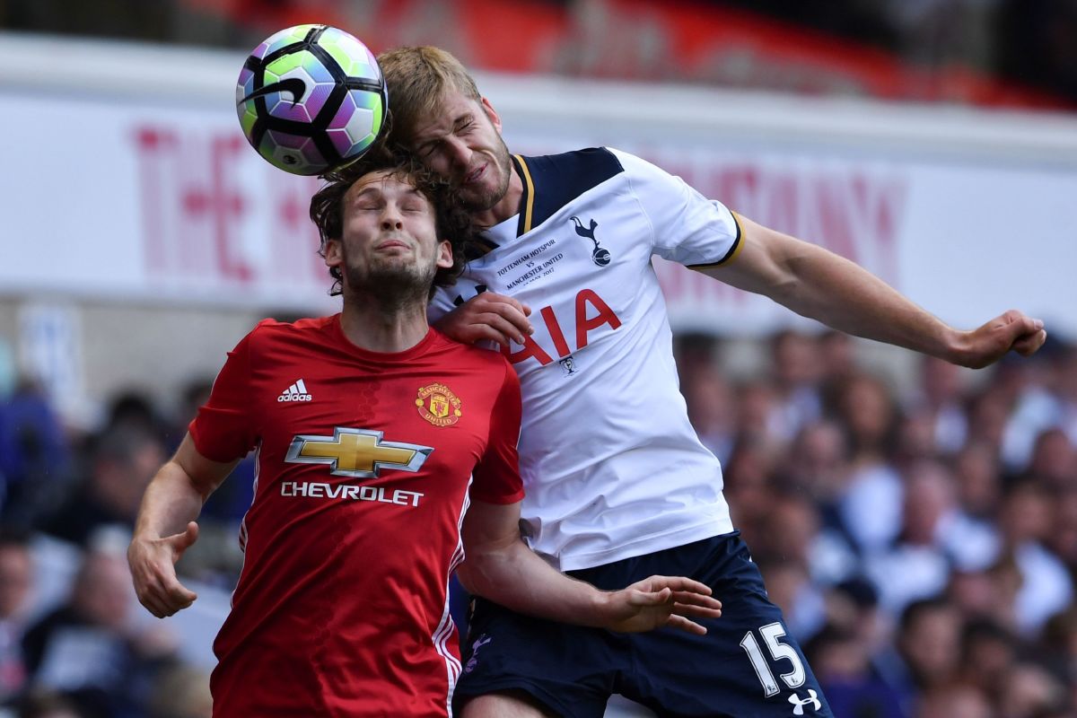 Manchester United's Dutch midfielder Daley Blind (L) vies with Tottenham Hotspur's English defender Eric Dier during the English Premier League football match between Tottenham Hotspur and Manchester United at White Hart Lane in London, on May 14, 2017. / AFP PHOTO / Ben STANSALL / RESTRICTED TO EDITORIAL USE. No use with unauthorized audio, video, data, fixture lists, club/league logos or 'live' services. Online in-match use limited to 75 images, no video emulation. No use in betting, games or single club/league/player publications.  /         (Photo credit should read BEN STANSALL/AFP/Getty Images)