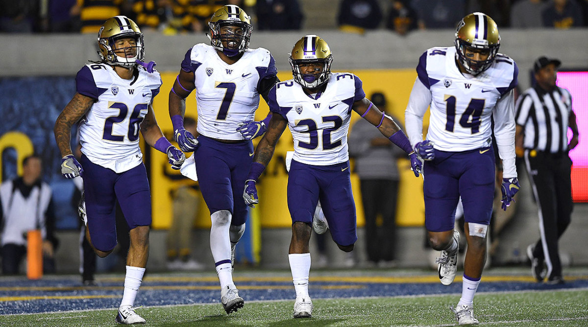 Budda Baker (No. 32) with Washington teammates Sidney Jones (26), Keishawn Bierria (7) and Jojo McIntosh (14).